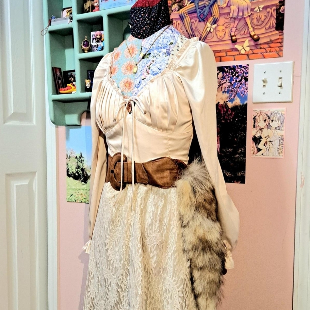 Cream ruffle blouse with long puff sleeves and a tie bow